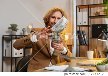 Business man wasting throwing money dollar cash success win lottery shopping at home office desk Business man wasting throwing money dollar cash success win lottery shopping at home office desk 121412120
