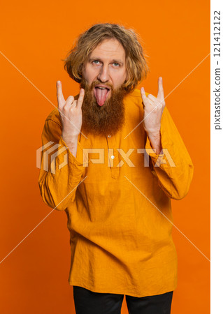 Happy joyful man showing rock n roll gesture by hands cool sign crazy expression dancing victory win 121412122