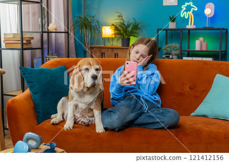 Upset child kid girl using smartphone playing game loses bad news fail education study test at home 121412156