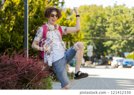 Excited happy man traveler shouting, celebrating success, winning, goal achievement, good news Excited happy man traveler shouting, celebrating success, winning, goal achievement, good news 121412330
