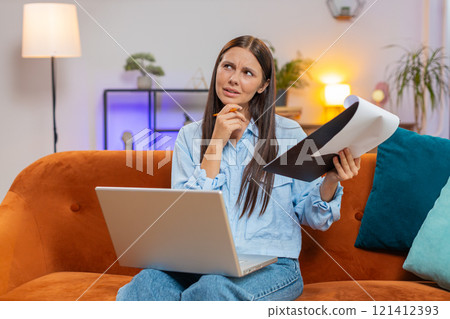 Woman freelancer accountant working with financial documents charts graph reports calculate taxes Woman freelancer accountant working with financial documents charts graph reports calculate taxes 121412393