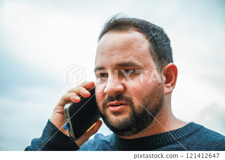 Man Clutches Phone While Hearing Tragic News 121412647
