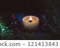 a beautiful scented candle in a transparent holder burns on a dark background. High quality photo 121413843