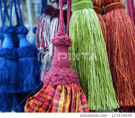 decorative brush pendants for the canopy. colored tassels made of thread for hanging on curtains. items for needlework sewing and embroidery for home comfort and window decoration. High quality photo 121414076