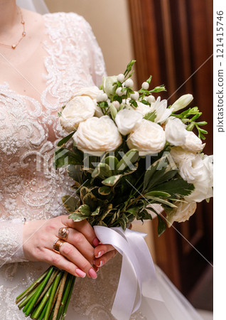 bouquet of white roses in the hands of the bride. vertical bouquet of white roses in the hands of the bride. vertical 121415746