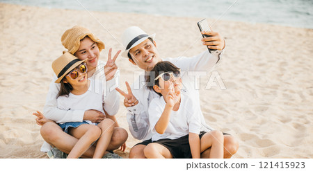 Family happiness unfolds on the beach as they take a delightful selfie near the sea creating a beautiful snapshot of their summer vacation. Laughter joy and carefree fun abound in this portrait. Family happiness unfolds on the beach as they take a delightful selfie near the sea creating a beautiful snapshot of their summer vacation. Laughter joy and carefree fun abound in this portrait. 121415923