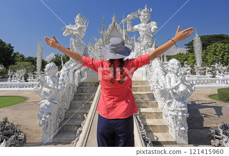 Teenager Girl tourist admiring the Wat Rong Khun (White Temple) in Chiang Mai, Thailand 121415960