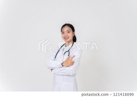 A doctor in uniform smiling and pointing at an empty space, as if she is recommending something. A doctor in uniform smiling and pointing at an empty space, as if she is recommending something. 121418090