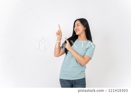 A beautiful Asian woman on a studio background, pointing her finger up as she recommend something. 121418303