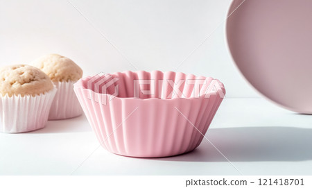 Pink silicone muffin baking mold with freshly baked muffins 121418701