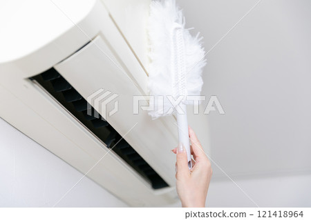 Hands cleaning the air conditioner Hands cleaning the air conditioner 121418964