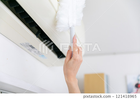 Hands cleaning the air conditioner Hands cleaning the air conditioner 121418965