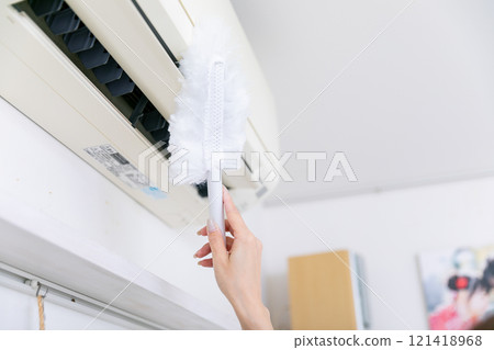 Hands cleaning the air conditioner Hands cleaning the air conditioner 121418968