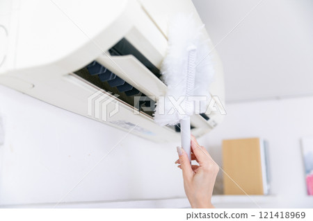 Hands cleaning the air conditioner Hands cleaning the air conditioner 121418969