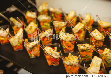 A contemporary hotel dining area featuring a sleek buffet setup. A contemporary hotel dining area featuring a sleek buffet setup. 121420072