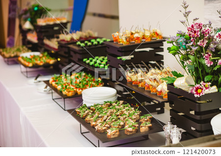 A contemporary hotel dining area featuring a sleek buffet setup. 121420073