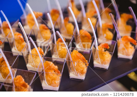 A contemporary hotel dining area featuring a sleek buffet setup. A contemporary hotel dining area featuring a sleek buffet setup. 121420078