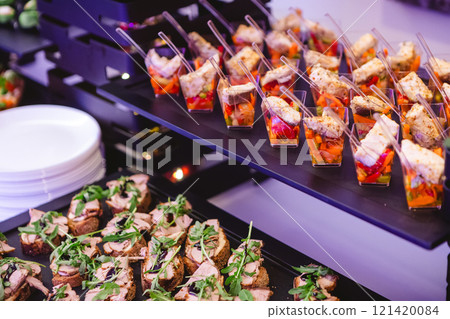 A contemporary hotel dining area featuring a sleek buffet setup. 121420084