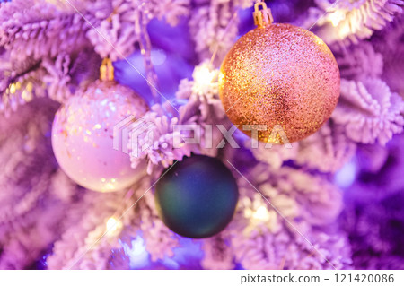 A close-up of a Christmas tree adorned with glittery ornaments. A close-up of a Christmas tree adorned with glittery ornaments. 121420086