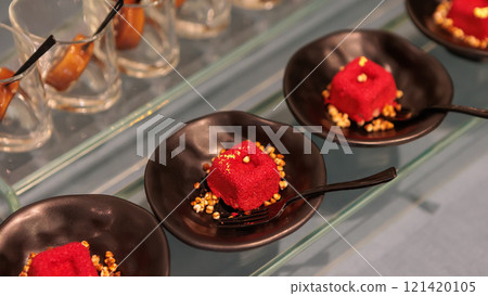 Delicious mini red velvet cakes with cream cheese frosting and grated cheese 121420105