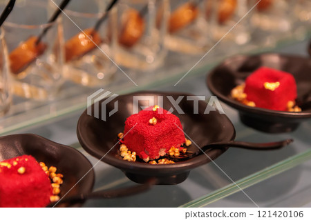 Delicious mini red velvet cakes with cream cheese frosting and grated cheese 121420106