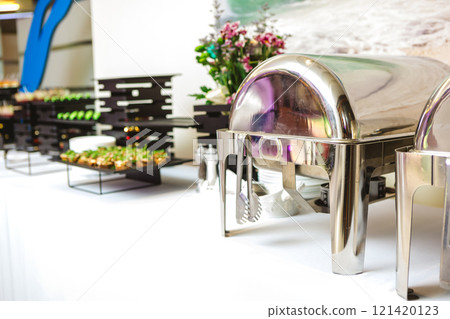 A contemporary hotel dining area featuring a sleek buffet setup and stylish seating arrangement 121420123