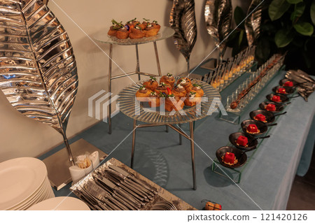 A contemporary hotel dining area featuring a sleek buffet setup and stylish seating arrangement 121420126
