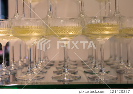 Towering pyramid of champagne glasses filled with bubbly 121420227