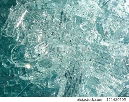 Close up of shattered glass fragments highlighting jagged edges and transparency Close up of shattered glass fragments highlighting jagged edges and transparency 121420605
