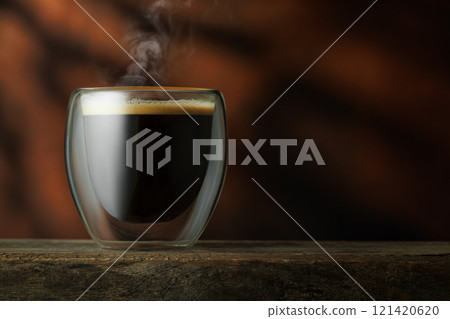 espresso in glass cup on table with brown background 121420620