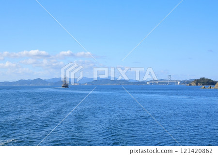 View of the Naruto Strait with a sightseeing boat cruising towards the Onaruto Bridge 121420862
