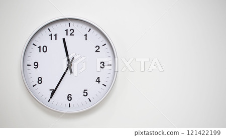 Minimalist White Clock with Silver Frame Striking 11.35/23.35 on White Background. Perfect for Time Management and Corporate Campaigns 121422199