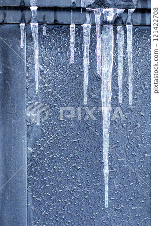 Icicles against a gray wall 121422708