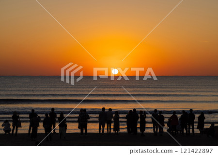 Tourists watching the sunset over the sea at Inasa Beach, Shimane Prefecture 121422897