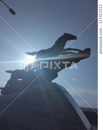 Fast horse sculpture and sunset 121423312