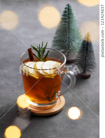 Homemade apple punch with fresh apples, cinnamon and rosemary in a cup on a dark background 121424837