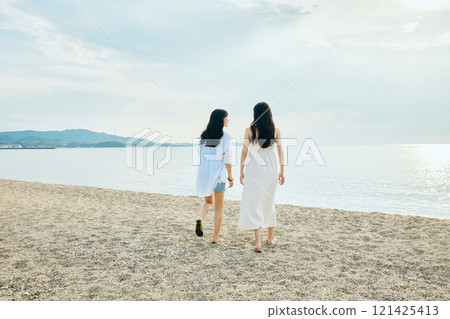 Woman walking on the beach in summer 121425413