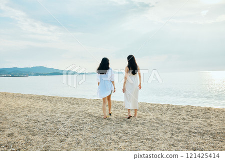 Woman walking on the beach in summer 121425414