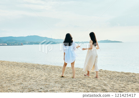 Woman walking on the beach in summer Woman walking on the beach in summer 121425417