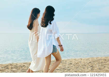Woman walking on the beach in summer 121425431
