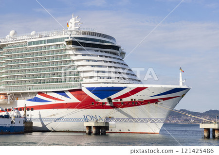Cruise ship. Boat. Vacation and travel concept with a generic cruise ship sailing on the calm ocean. Luxury cruise liner. Cargo sea port and container terminal. Large cranes on a commercial dock. Cruise ship. Boat. Vacation and travel concept with a generic cruise ship sailing on the calm ocean. Luxury cruise liner. Cargo sea port and container terminal. Large cranes on a commercial dock. 121425486