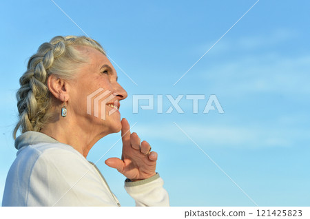 Portrait of a beautiful elderly woman in the park 121425823
