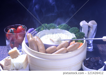 Cheese fondue in a steaming basket 121426412