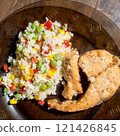 rice, vegetables and fish on dark plate 121426845