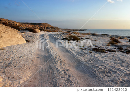 Shell coast of the Caspian Sea. Road along the sea. Shell coast of the Caspian Sea. Road along the sea. 121428910