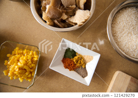 Assorted ingredients including rice, spices, corn, and mushrooms for cooking Assorted ingredients including rice, spices, corn, and mushrooms for cooking 121429270