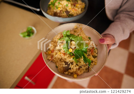 Delicious Bowl of Vegetable Paella Garnished With Fresh Parsley Ready to Enjoy Delicious Bowl of Vegetable Paella Garnished With Fresh Parsley Ready to Enjoy 121429274