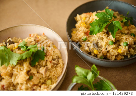 Delicious homemade vegetable rice dish with herbs served in ceramic bowls Delicious homemade vegetable rice dish with herbs served in ceramic bowls 121429278