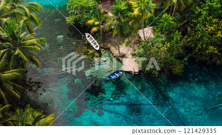 Lake with blue water and woman on pier in Indonesia. Aerial view Lake with blue water and woman on pier in Indonesia. Aerial view 121429335