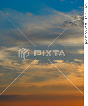 Real majestic sunrise sundown sky background with gentle colorful clouds without birds. 121429428